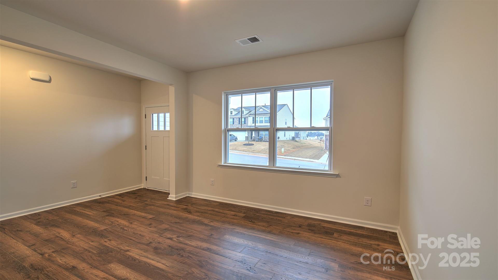 356 Wheatfield Road Fletcher, NC 28732 - Photo 10 of 25 a view of an empty room with wooden floor and a window
