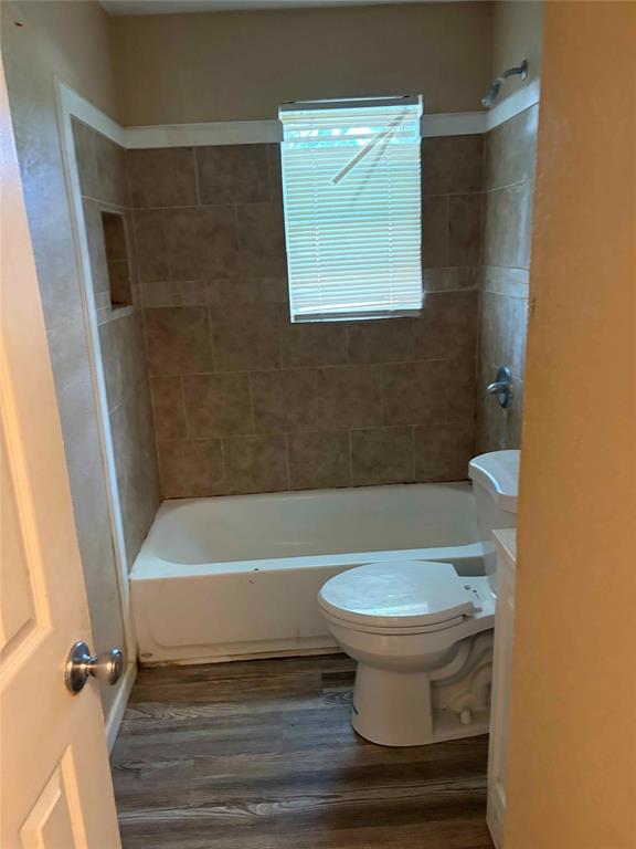701 West Colorado Street Groesbeck, TX 76642 - Photo 3 of 12 Full bath with dark wood-style floors, tub / shower combination, and vanity