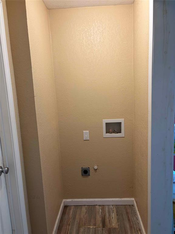 701 West Colorado Street Groesbeck, TX 76642 - Photo 8 of 12 Laundry area featuring dark wood-type flooring and hookup for a washing machine