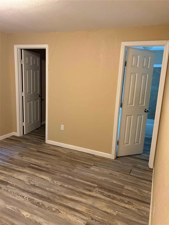 701 West Colorado Street Groesbeck, TX 76642 - Photo 9 of 12 Empty room with dark wood-style flooring