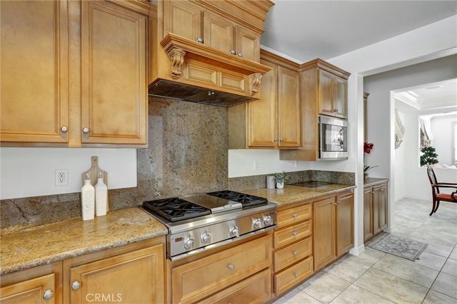 a kitchen with stainless steel appliances granite countertop a stove and a sink