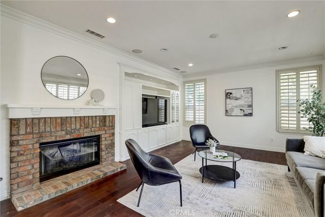 a living room with furniture fireplace and window