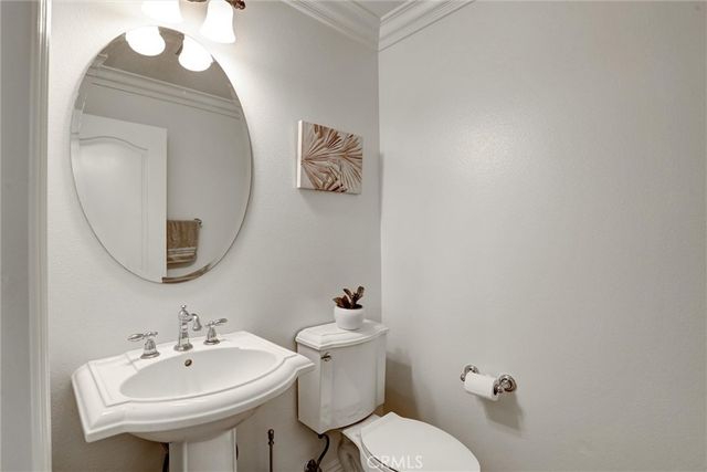 a bathroom with a sink mirror and toilet