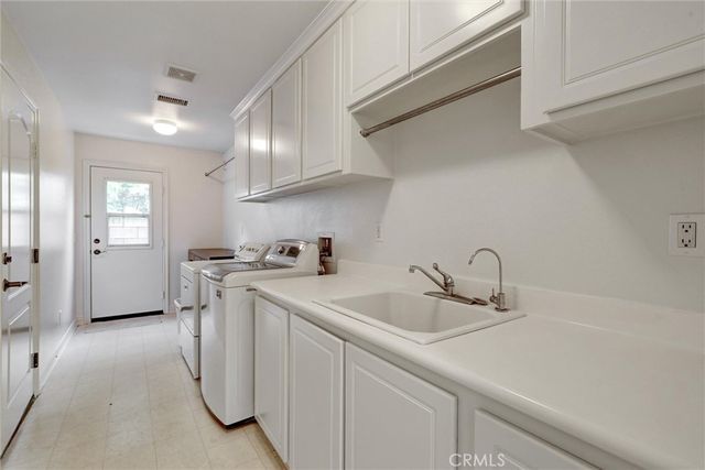 a kitchen with a sink cabinets and appliances
