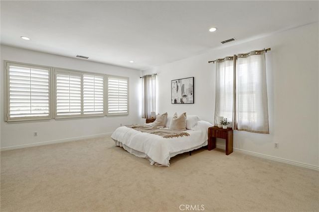 a spacious bedroom with a bed and a couch