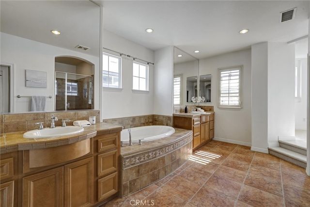 a bathroom with a sink mirror and a bathtub