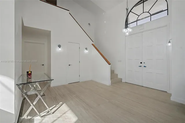 a kitchen with stainless steel appliances granite countertop a sink and a refrigerator