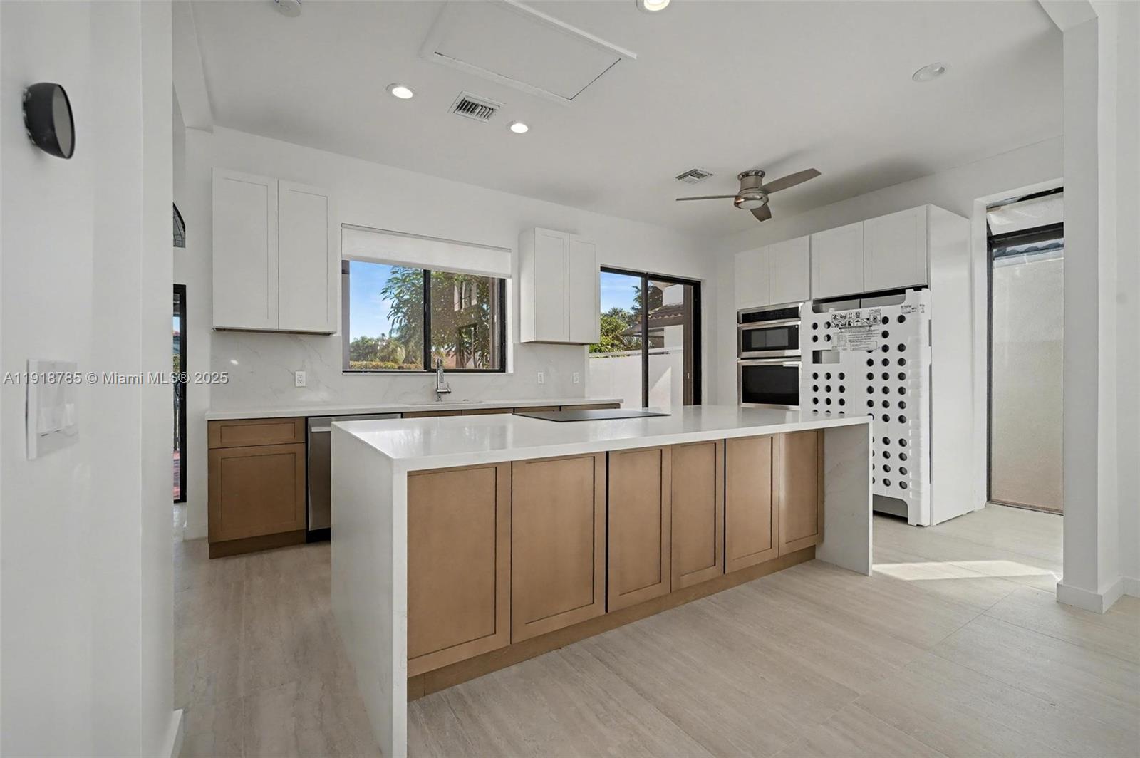 6438 Via Rosa Boca Raton, FL 33433 - Photo 20 of 45 a kitchen with stainless steel appliances granite countertop a sink and a refrigerator