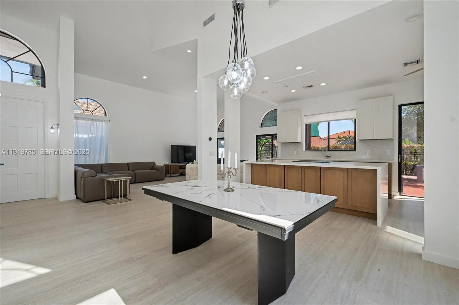 6438 Via Rosa Boca Raton, FL 33433 - Photo 23 of 45 a room with stainless steel appliances kitchen island granite countertop a stove and a sink