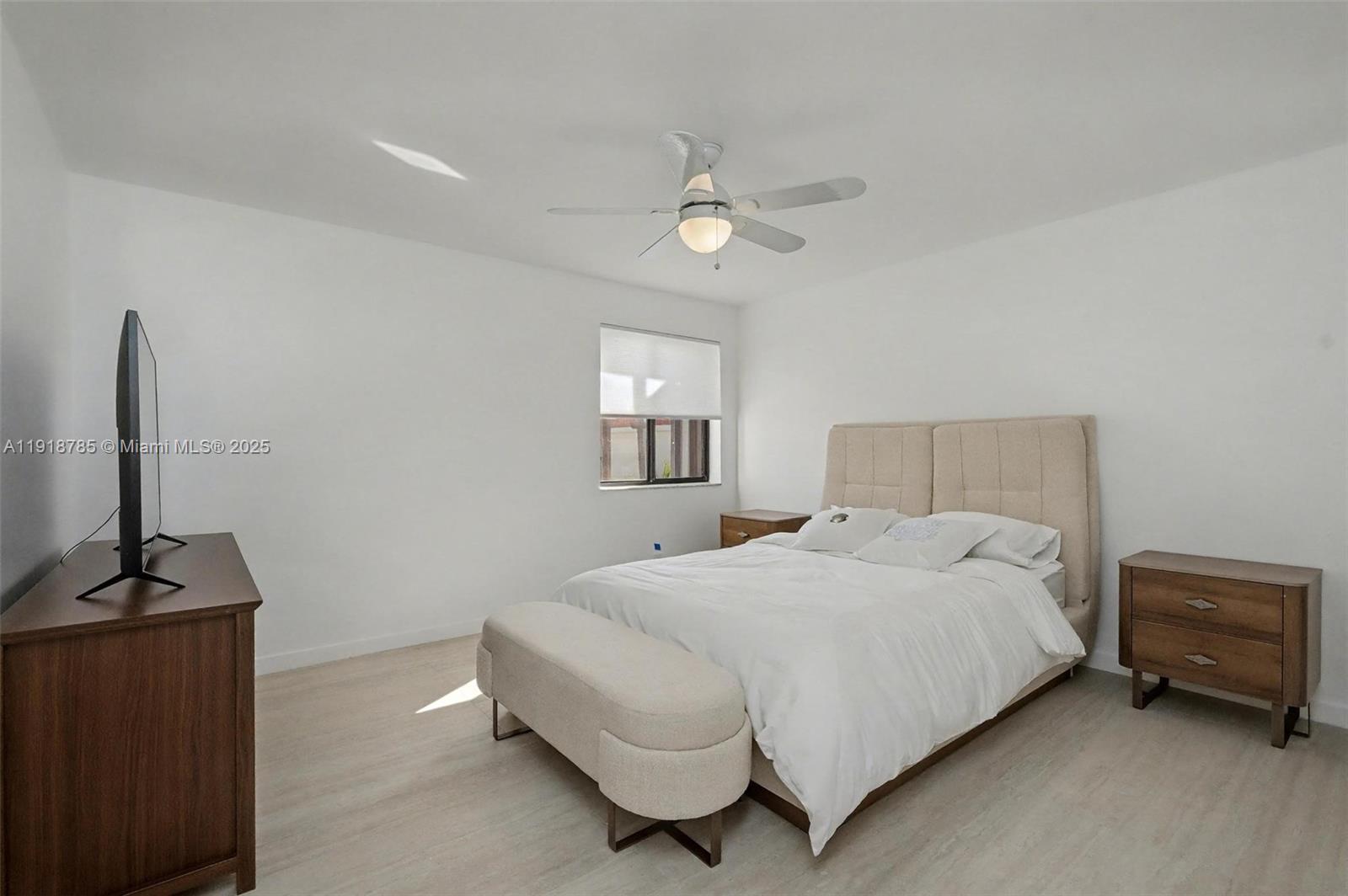 6438 Via Rosa Boca Raton, FL 33433 - Photo 27 of 45 a bedroom with a bed and a flat tv screen on a dresser