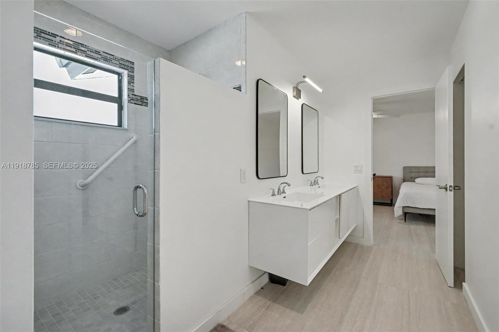 6438 Via Rosa Boca Raton, FL 33433 - Photo 29 of 45 a bathroom with a double vanity sink mirror and shower