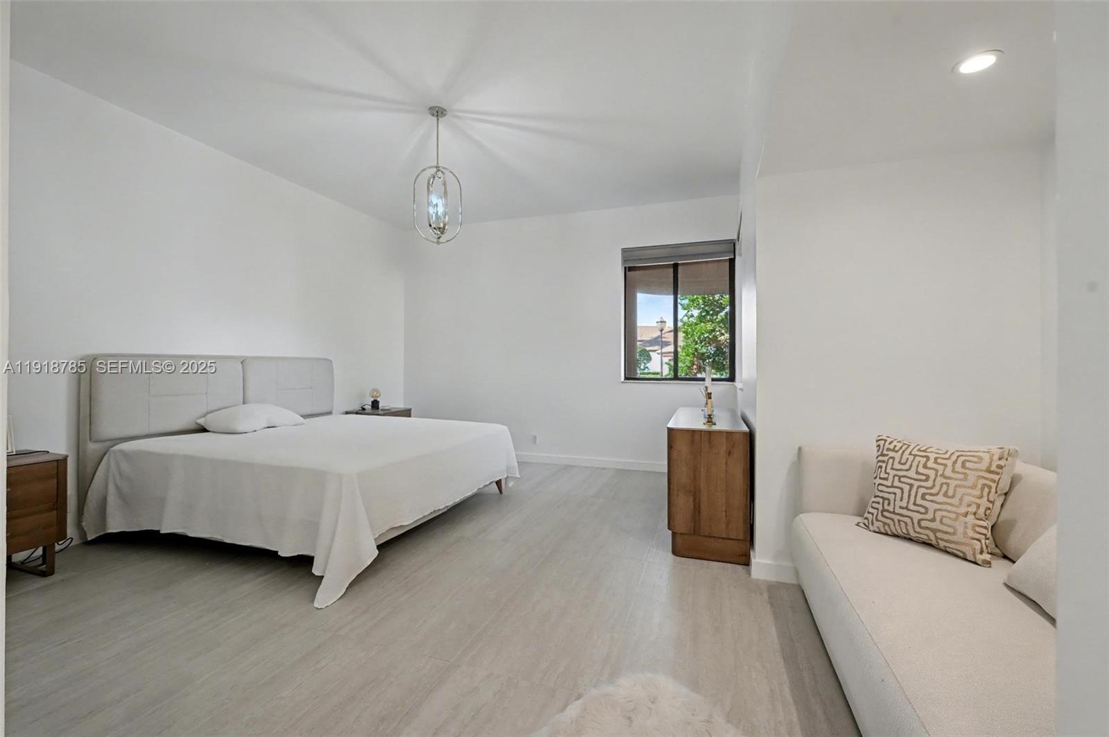 6438 Via Rosa Boca Raton, FL 33433 - Photo 33 of 45 a bedroom with a bed and a couch