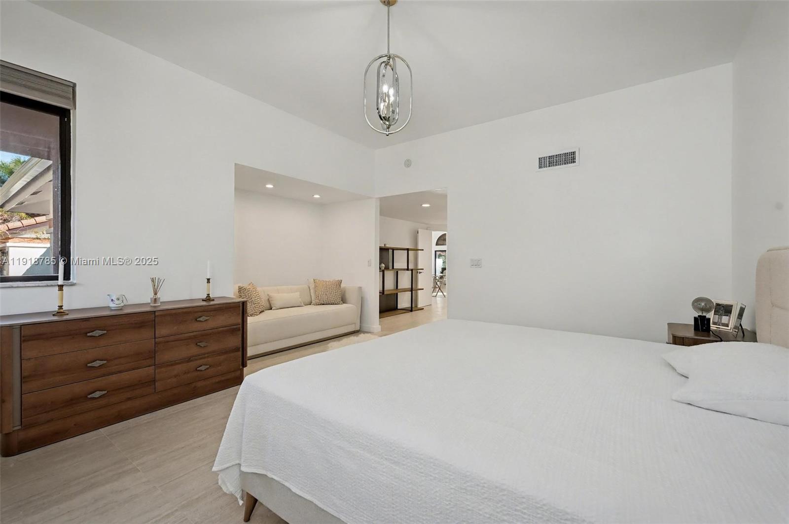 6438 Via Rosa Boca Raton, FL 33433 - Photo 35 of 45 a bedroom with a bed and a dresser