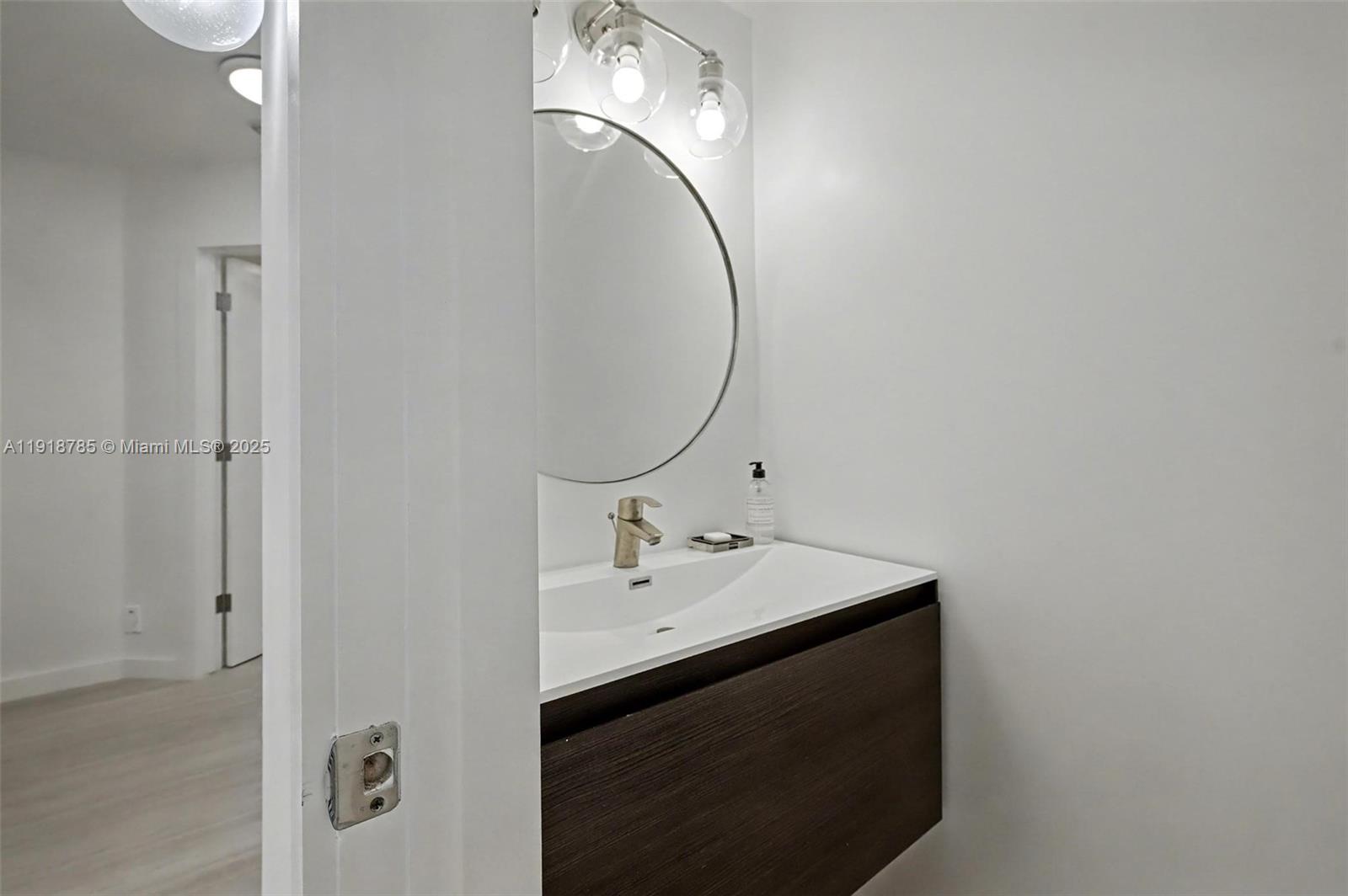 6438 Via Rosa Boca Raton, FL 33433 - Photo 42 of 45 a bathroom with a sink and a mirror