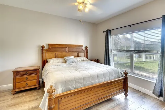 a bedroom with a bed and a night stand