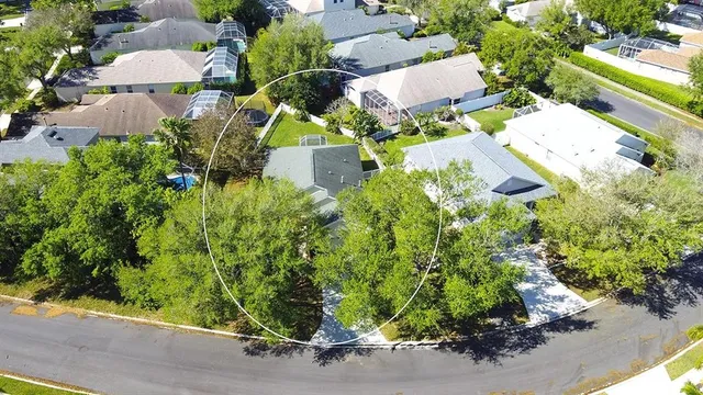 an aerial view of a house with a yard and garden