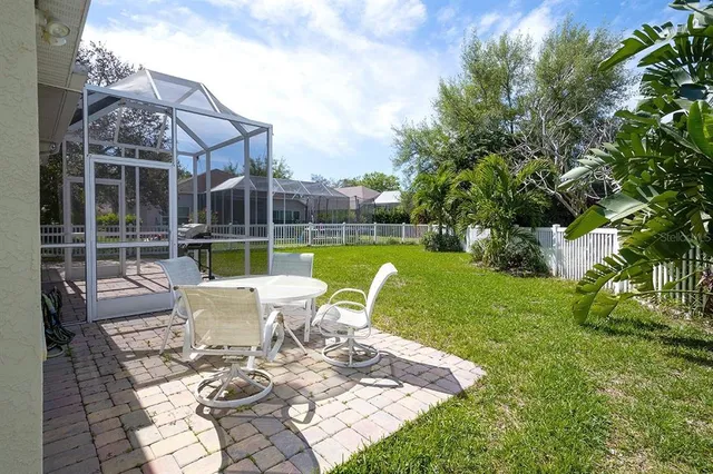 a view of a house with backyard sitting area and garden