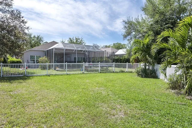 a view of an house with backyard space and balcony