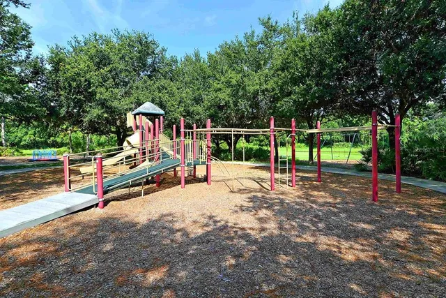 a view of park with swings and slides