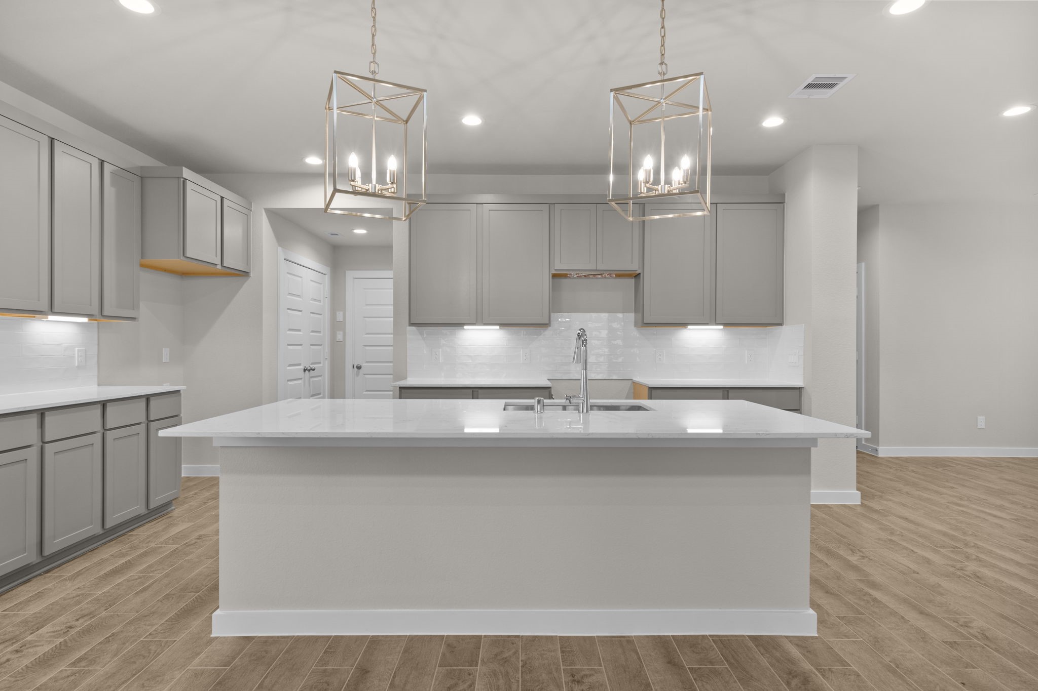 3034 Spitfire Drive Rosenberg, TX 77471 - Photo 2 of 47 a large kitchen with kitchen island a sink stainless steel appliances and cabinets