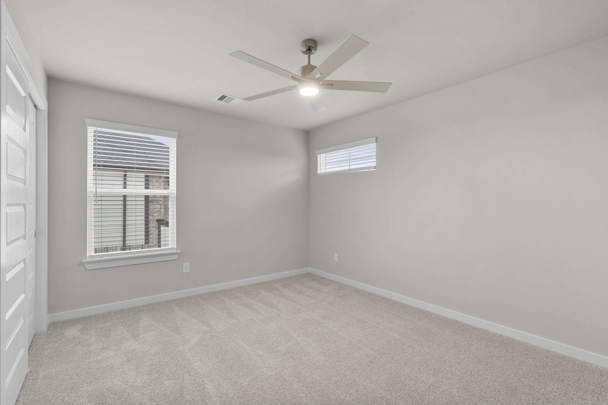 3034 Spitfire Drive Rosenberg, TX 77471 - Photo 23 of 47 an empty room with a window and ceiling fan