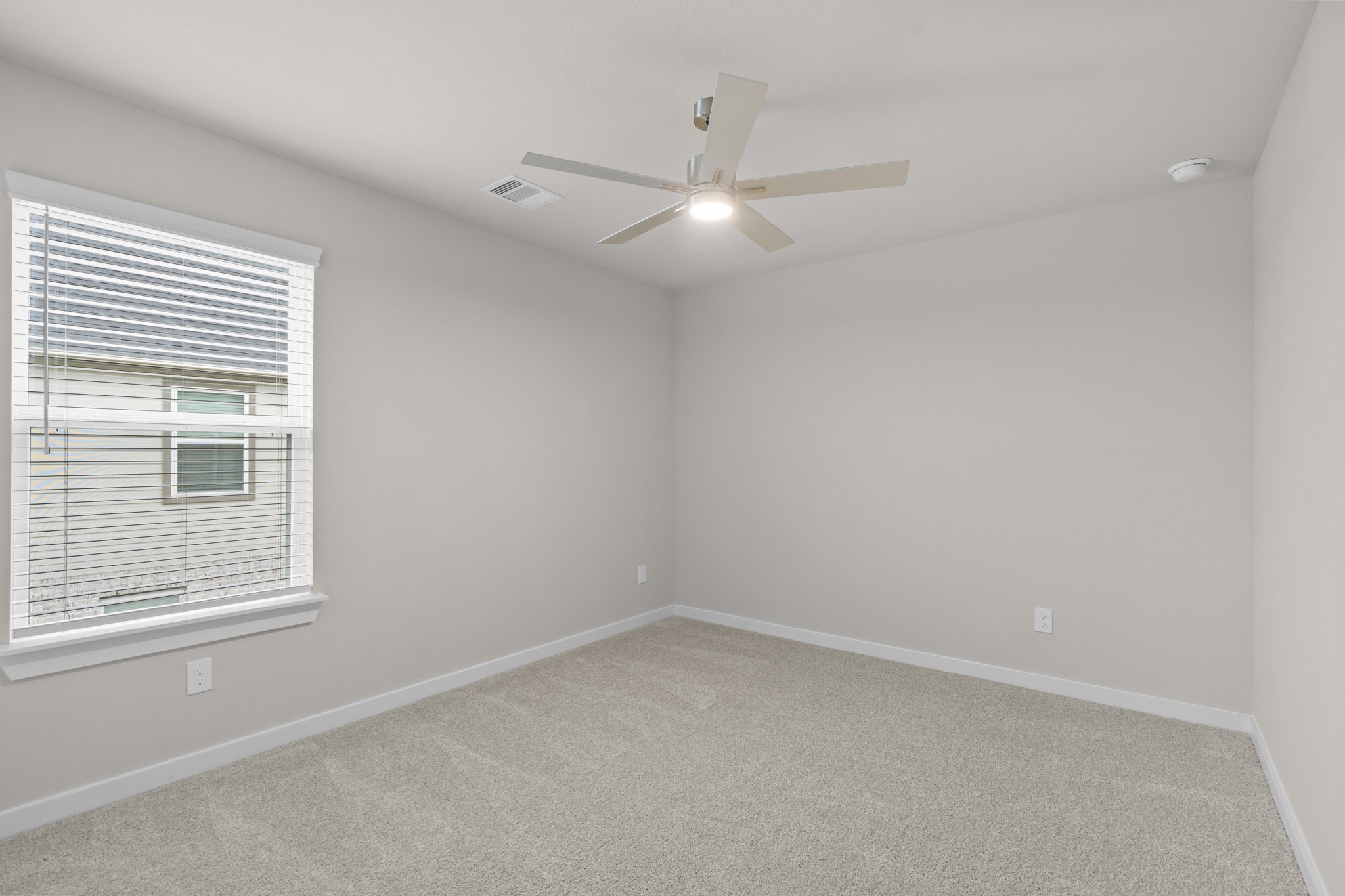 3034 Spitfire Drive Rosenberg, TX 77471 - Photo 26 of 47 an empty room with a window and ceiling fan