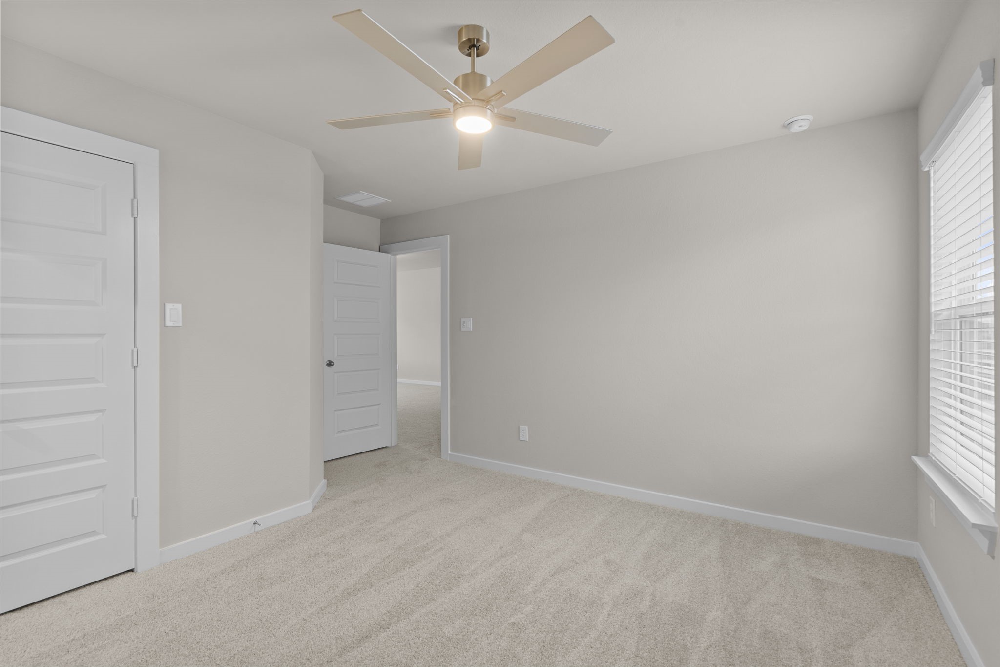 3034 Spitfire Drive Rosenberg, TX 77471 - Photo 31 of 47 an empty room with a window and a fan