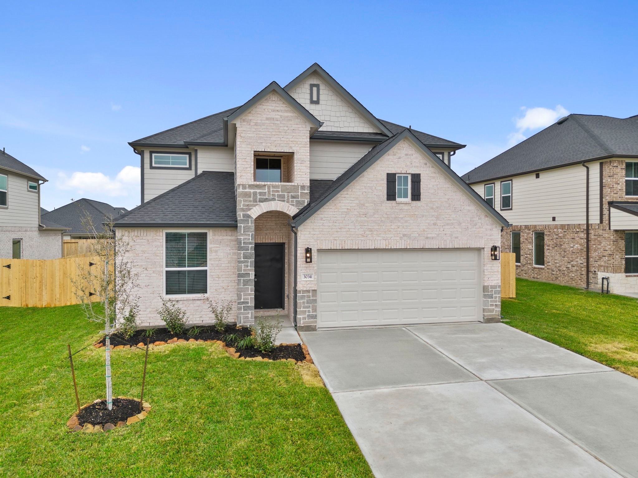 3034 Spitfire Drive Rosenberg, TX 77471 - Photo 37 of 47 a front view of a house with a yard and garage