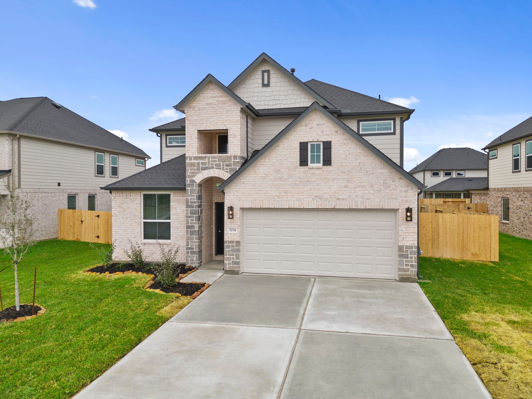 3034 Spitfire Drive Rosenberg, TX 77471 - Photo 38 of 47 a front view of a house with a yard and garage