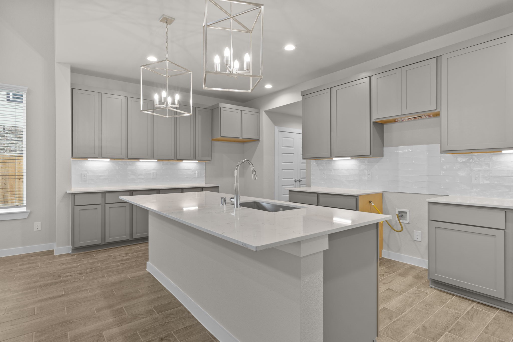 3034 Spitfire Drive Rosenberg, TX 77471 - Photo 4 of 47 a kitchen with kitchen island a sink stainless steel appliances and cabinets