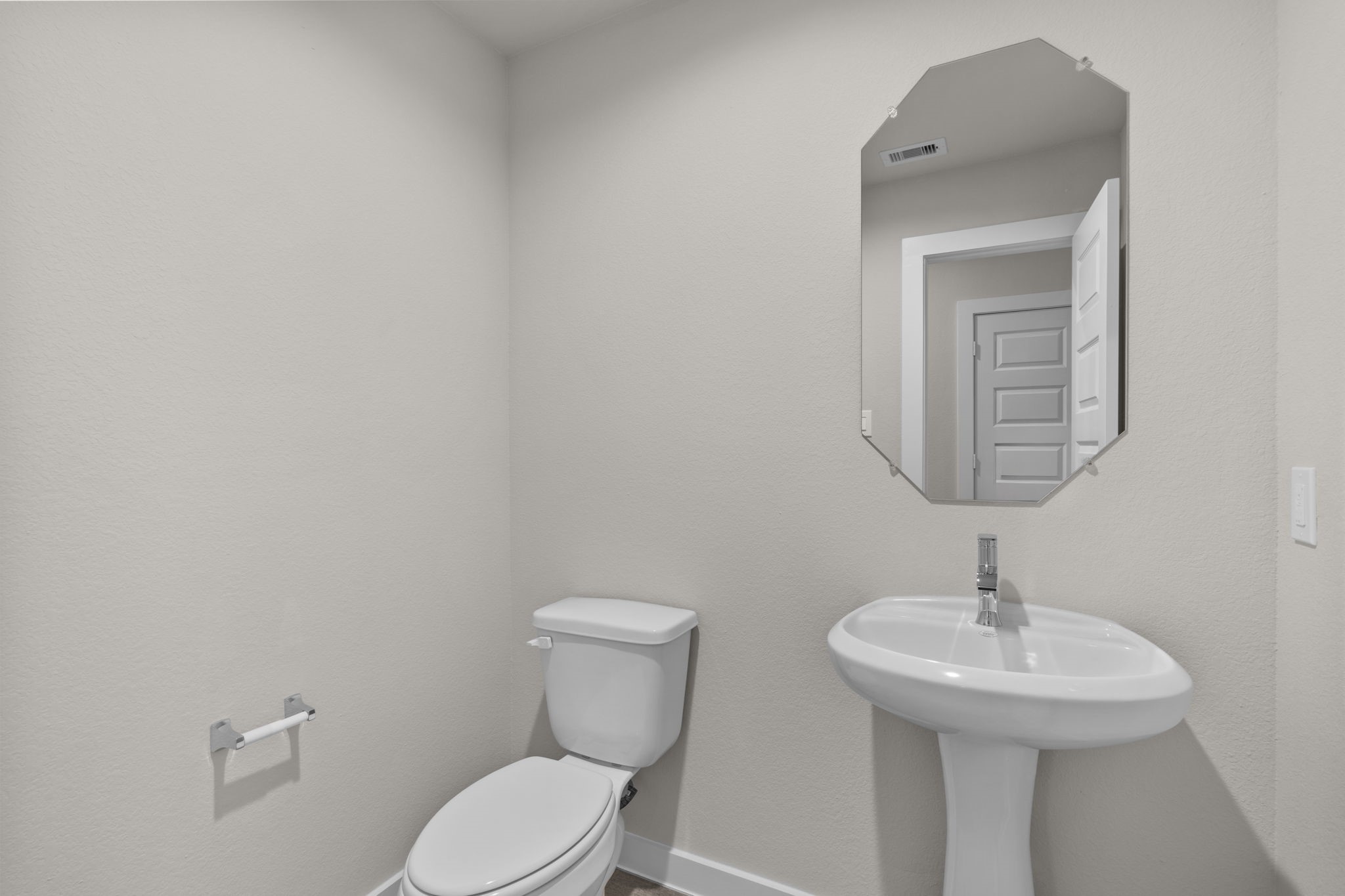 3034 Spitfire Drive Rosenberg, TX 77471 - Photo 9 of 47 a bathroom with a toilet a sink and mirror