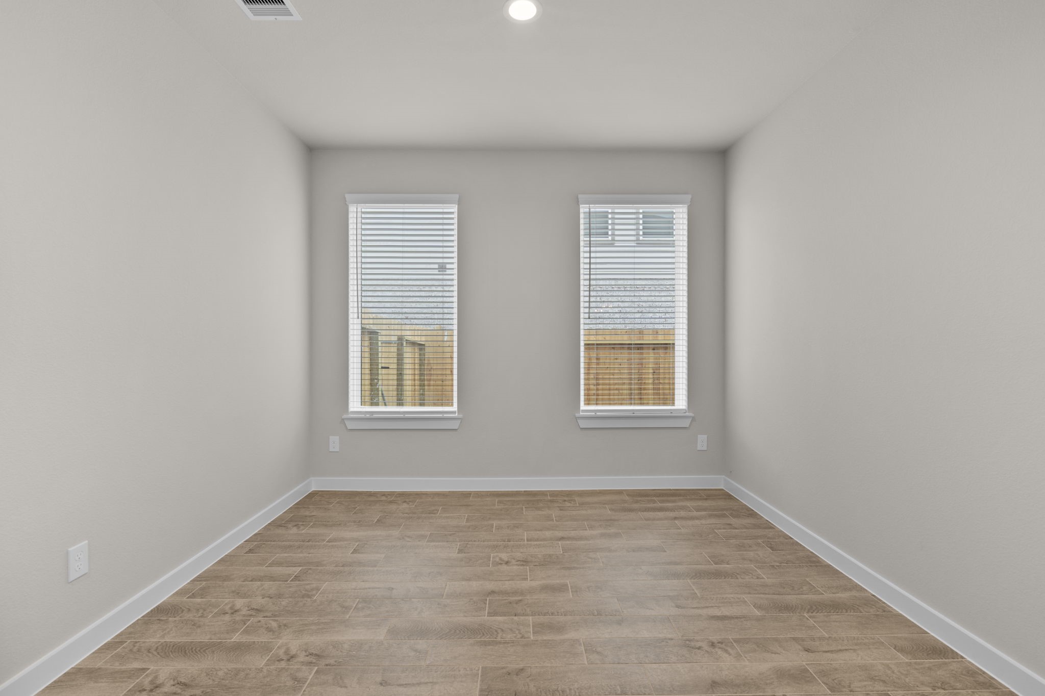 3034 Spitfire Drive Rosenberg, TX 77471 - Photo 10 of 47 an empty room with wooden floor and windows