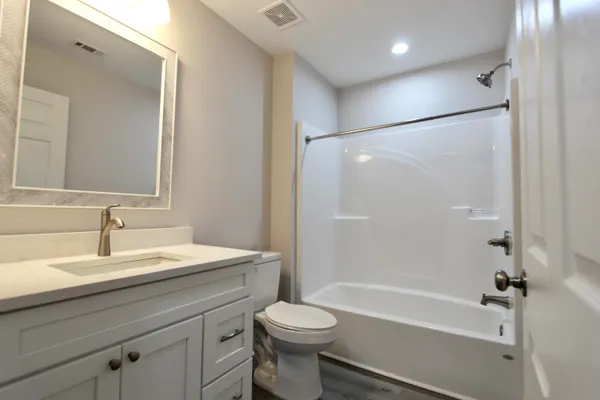 a bathroom with a sink a toilet and a bathtub
