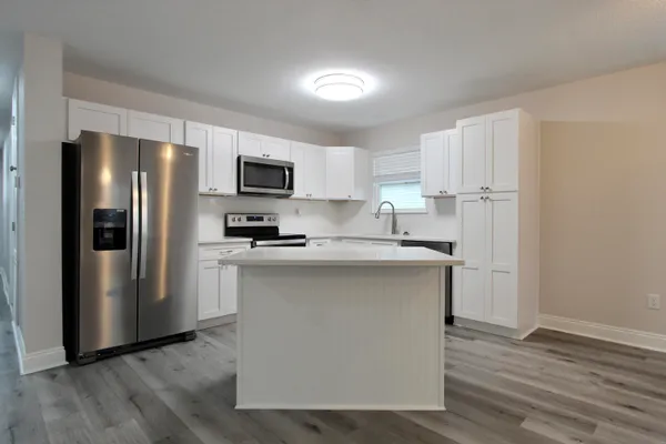 a kitchen with stainless steel appliances a refrigerator stove microwave and sink