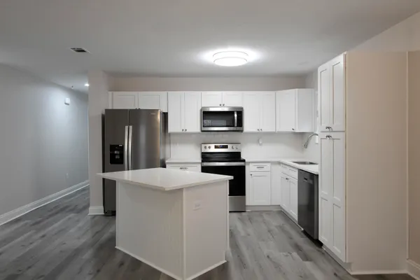 a kitchen with stainless steel appliances a refrigerator stove and microwave