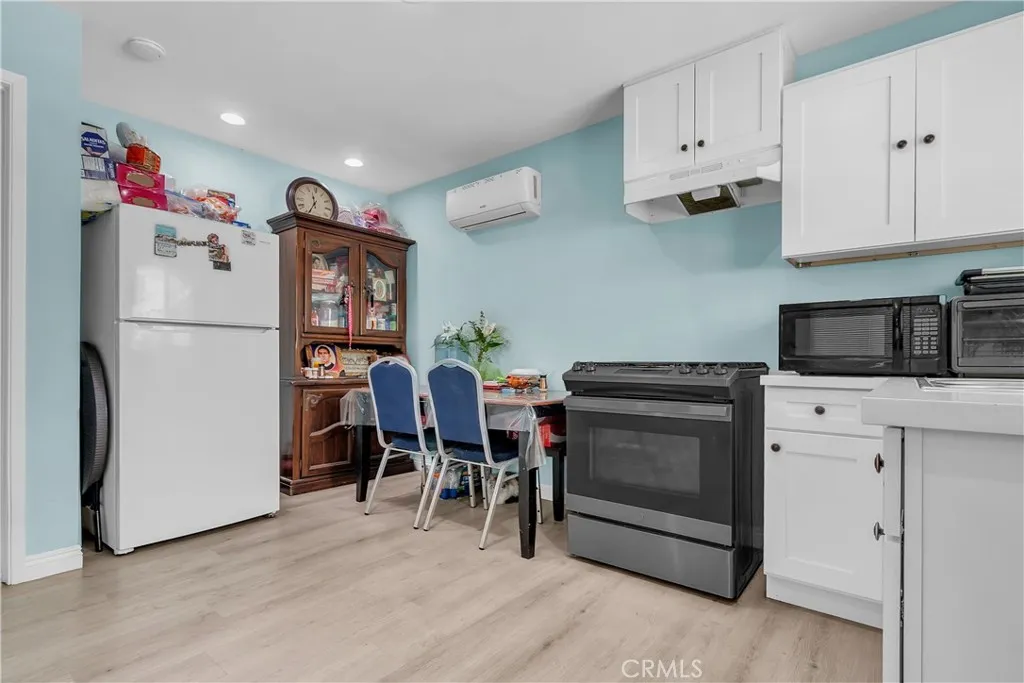 3738 Ahern Drive Baldwin Park, CA 91706 - Photo 26 of 36 a kitchen with refrigerator and cabinets