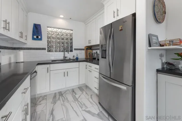 a kitchen with stainless steel appliances granite countertop a stove and a microwave