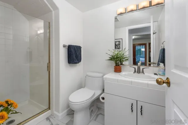 a bedroom with bed and a balcony