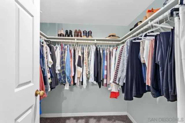 a bathroom with a toilet a sink a mirror a bathtub and vanity