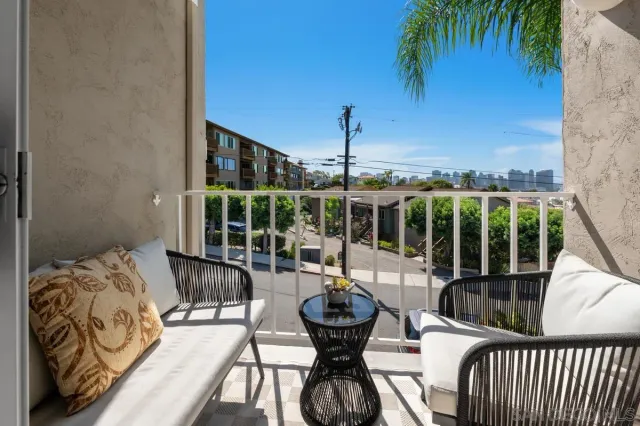 a front view of a house with outdoor seating and barbeque oven