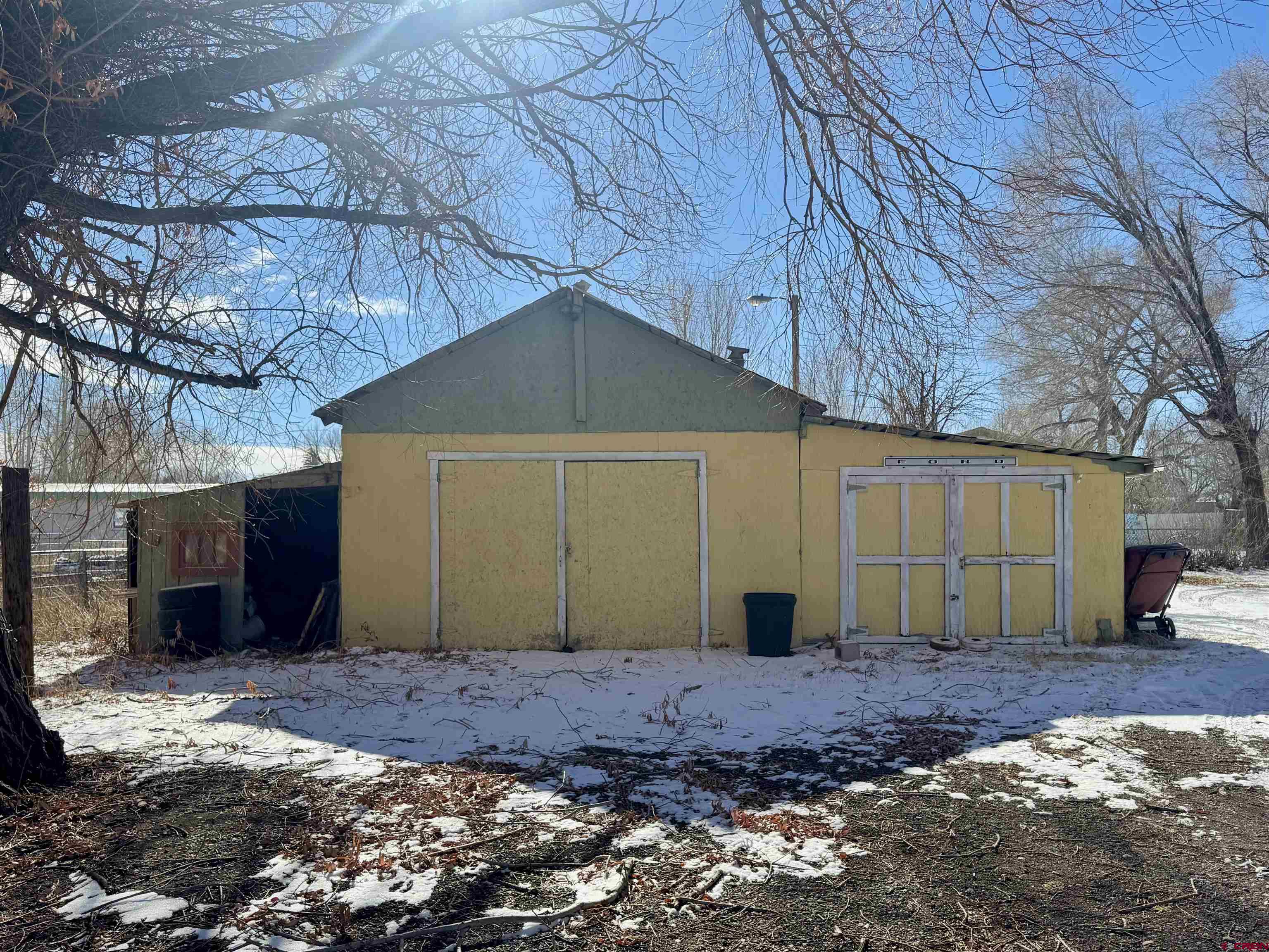 420 North 5th Street Manassa, CO 81141 - Photo 11 of 21 a view of a backyard with potted plants and large tree