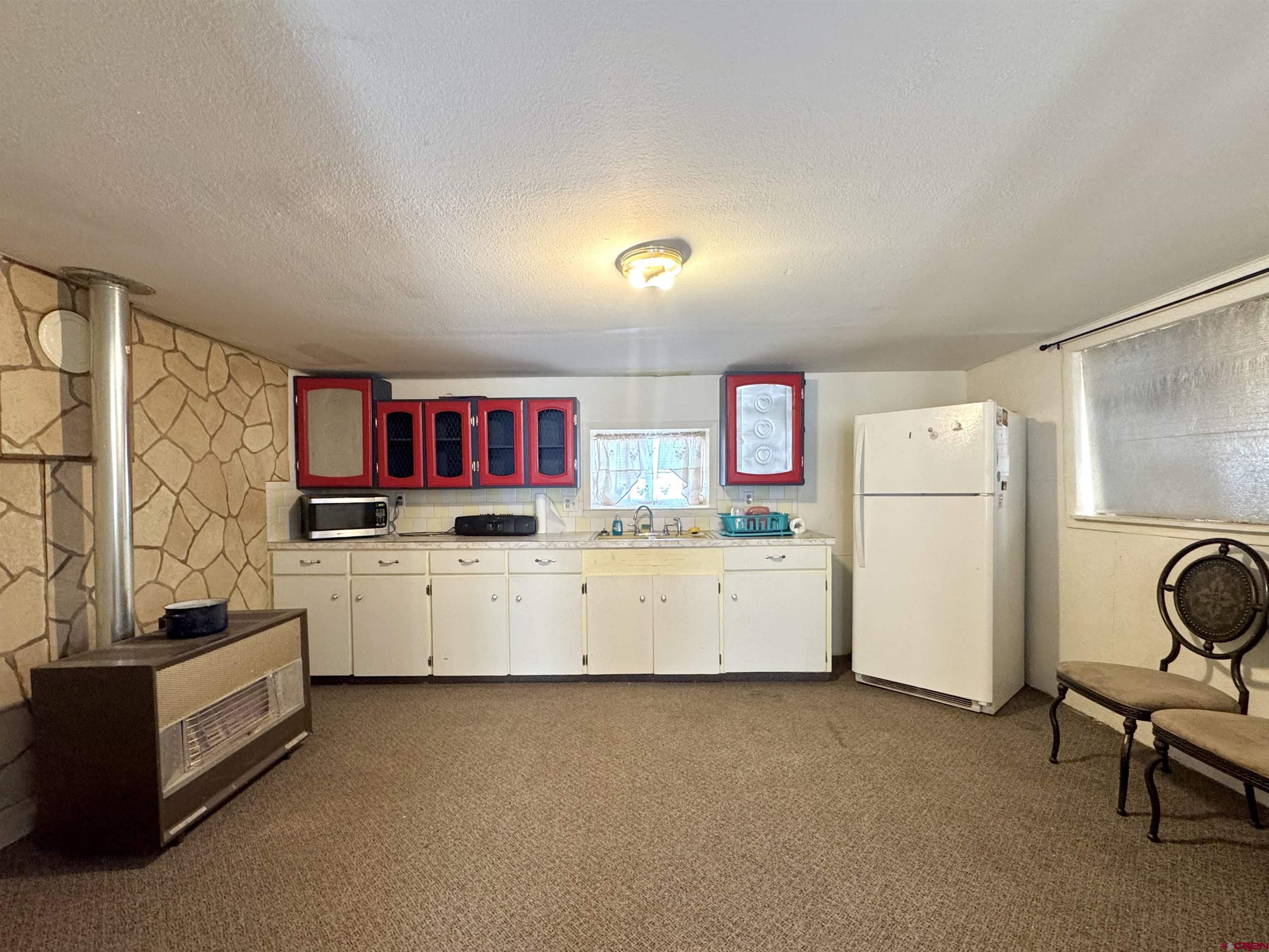 420 North 5th Street Manassa, CO 81141 - Photo 14 of 21 a kitchen with sink cabinets and white appliances