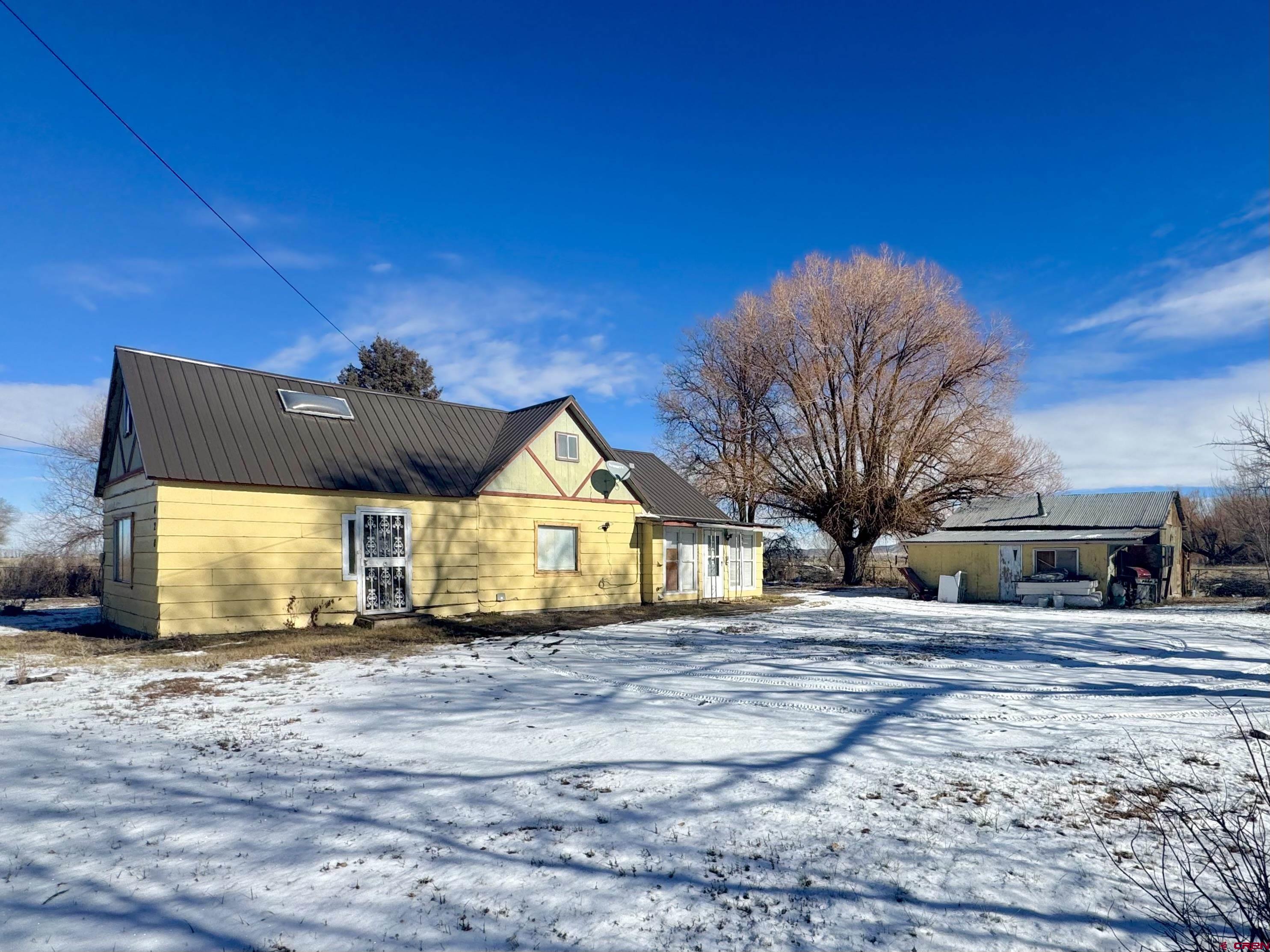 420 North 5th Street Manassa, CO 81141 - Photo 2 of 21 a front view of a house with a yard