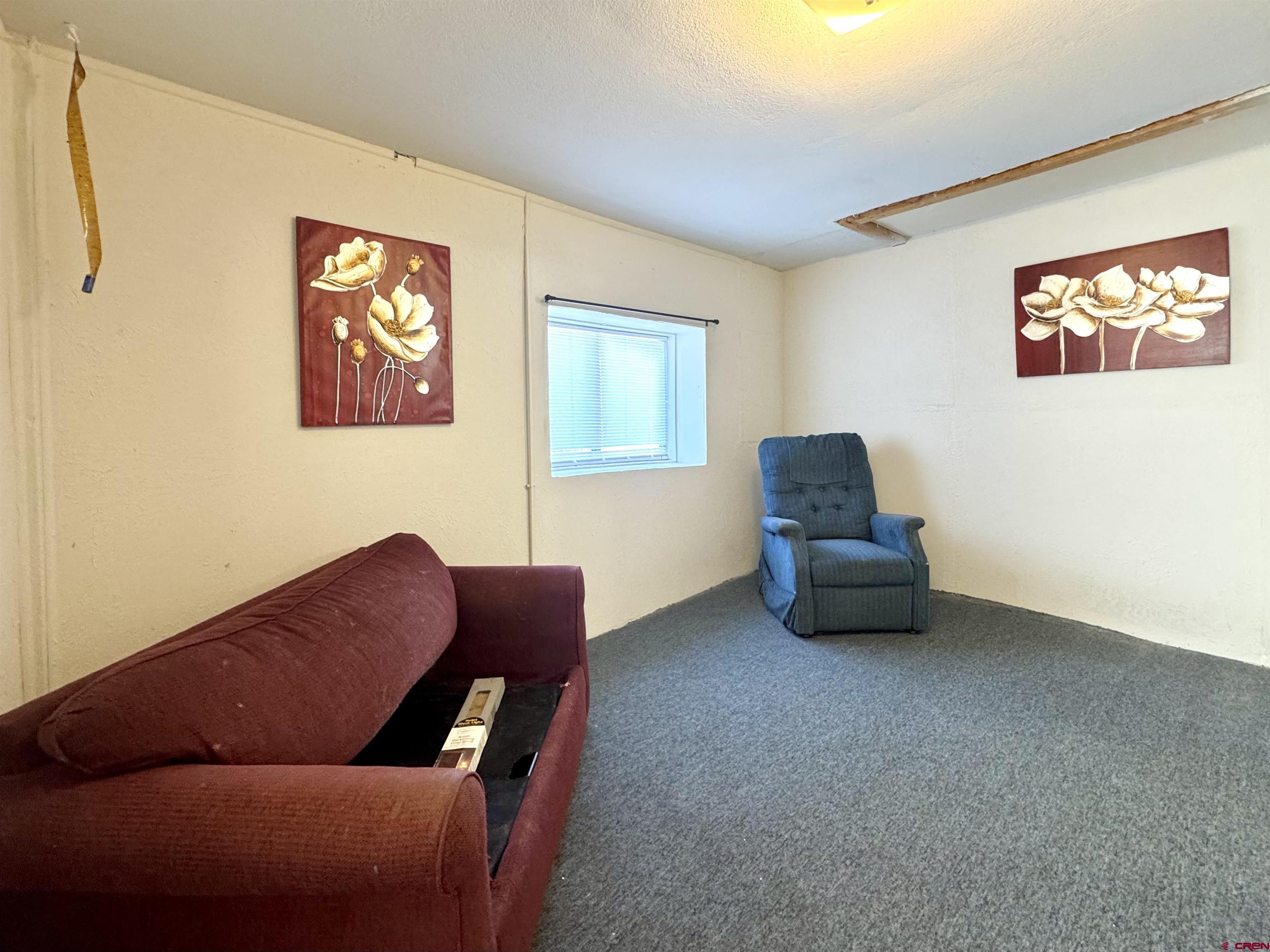 420 North 5th Street Manassa, CO 81141 - Photo 5 of 21 a living room with furniture and a chair