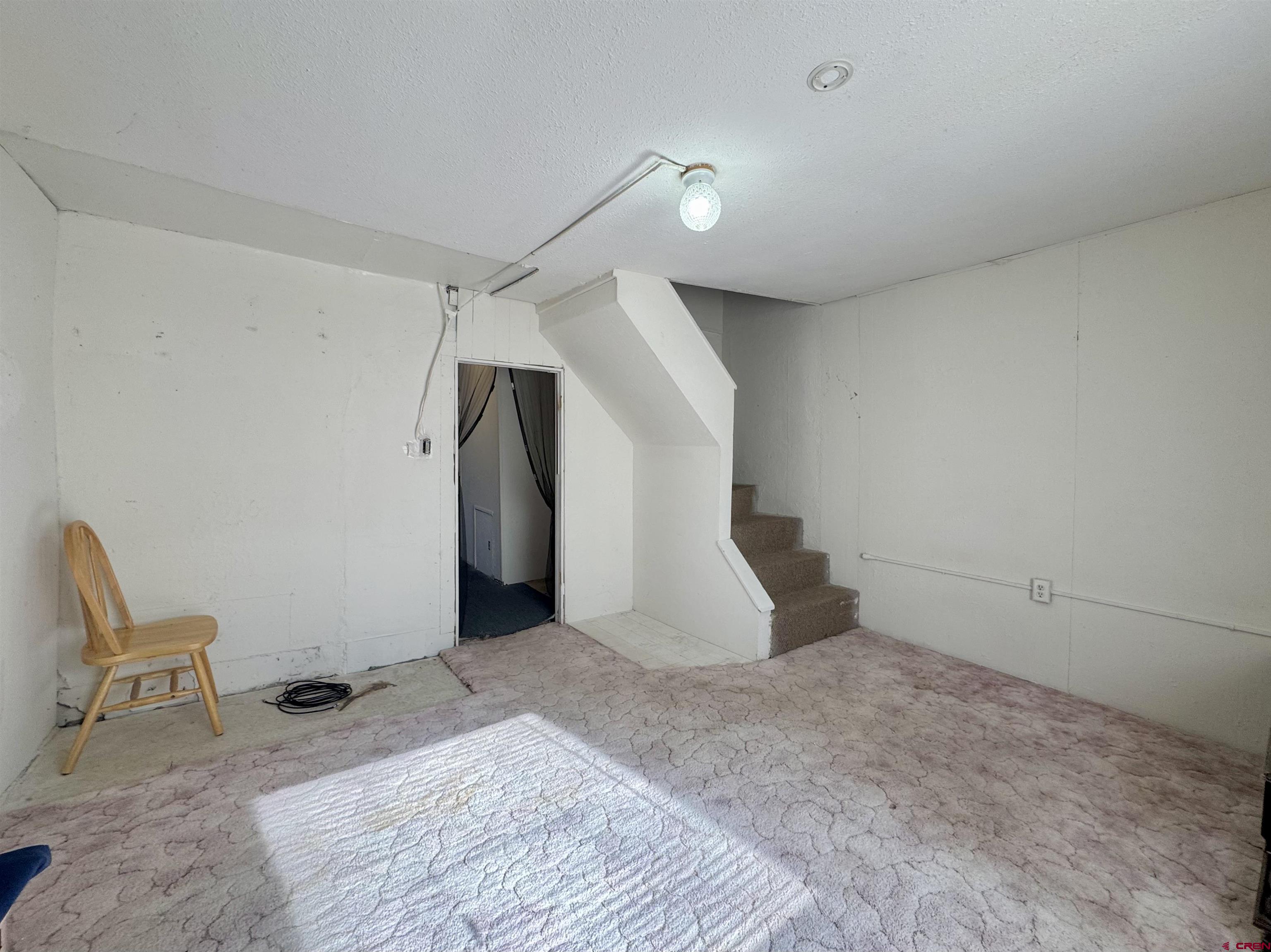420 North 5th Street Manassa, CO 81141 - Photo 8 of 21 a view of a livingroom with wooden floor and white walls