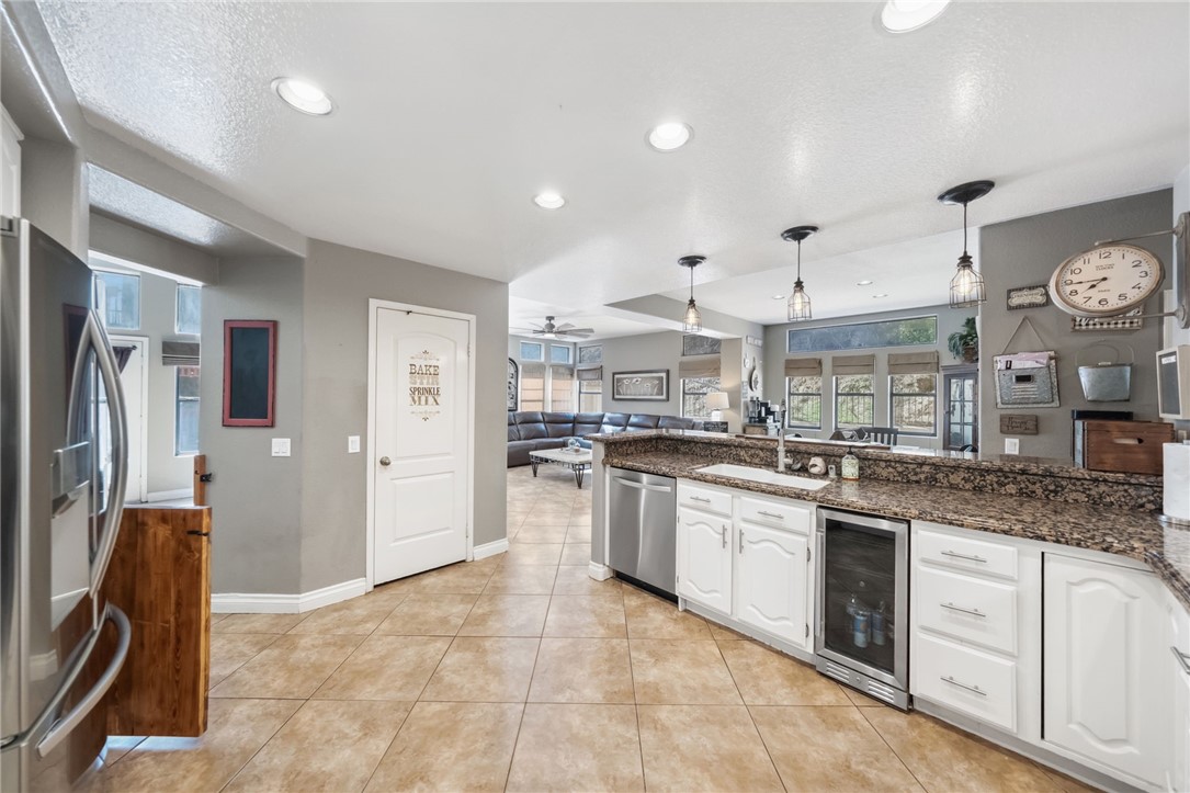 3270 Star Canyon Circle Corona, CA 92882 - Photo 13 of 55 a kitchen with stainless steel appliances granite countertop a sink refrigerator and cabinets