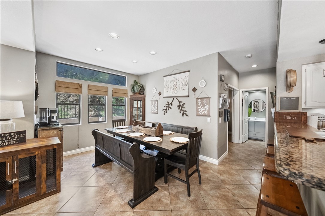 3270 Star Canyon Circle Corona, CA 92882 - Photo 17 of 55 a kitchen with stainless steel appliances kitchen island granite countertop a table and chairs in it