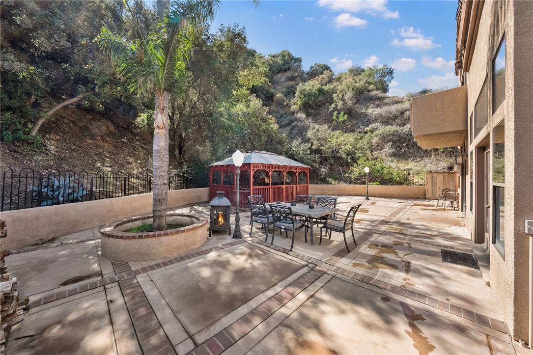 3270 Star Canyon Circle Corona, CA 92882 - Photo 24 of 55 a view of a patio with table and chairs and potted plants