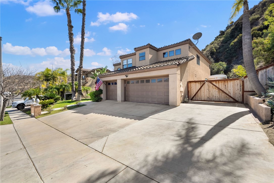 3270 Star Canyon Circle Corona, CA 92882 - Photo 3 of 55 a view of a white house with a yard and table and chairs