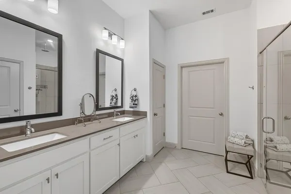 a bathroom with a granite countertop sink double and mirror